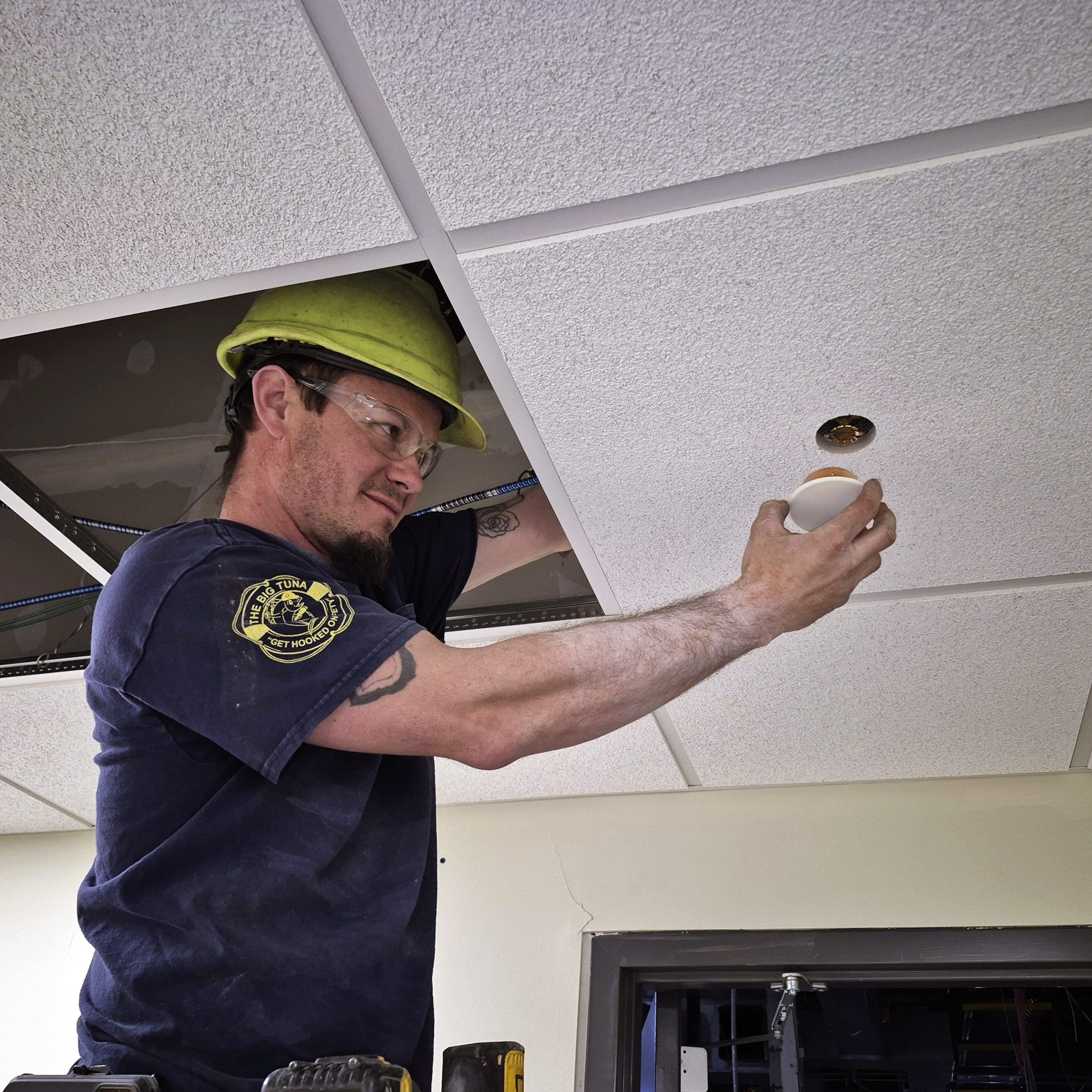 employee replacing sprinkler head
